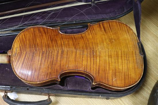 A cased violin and bows